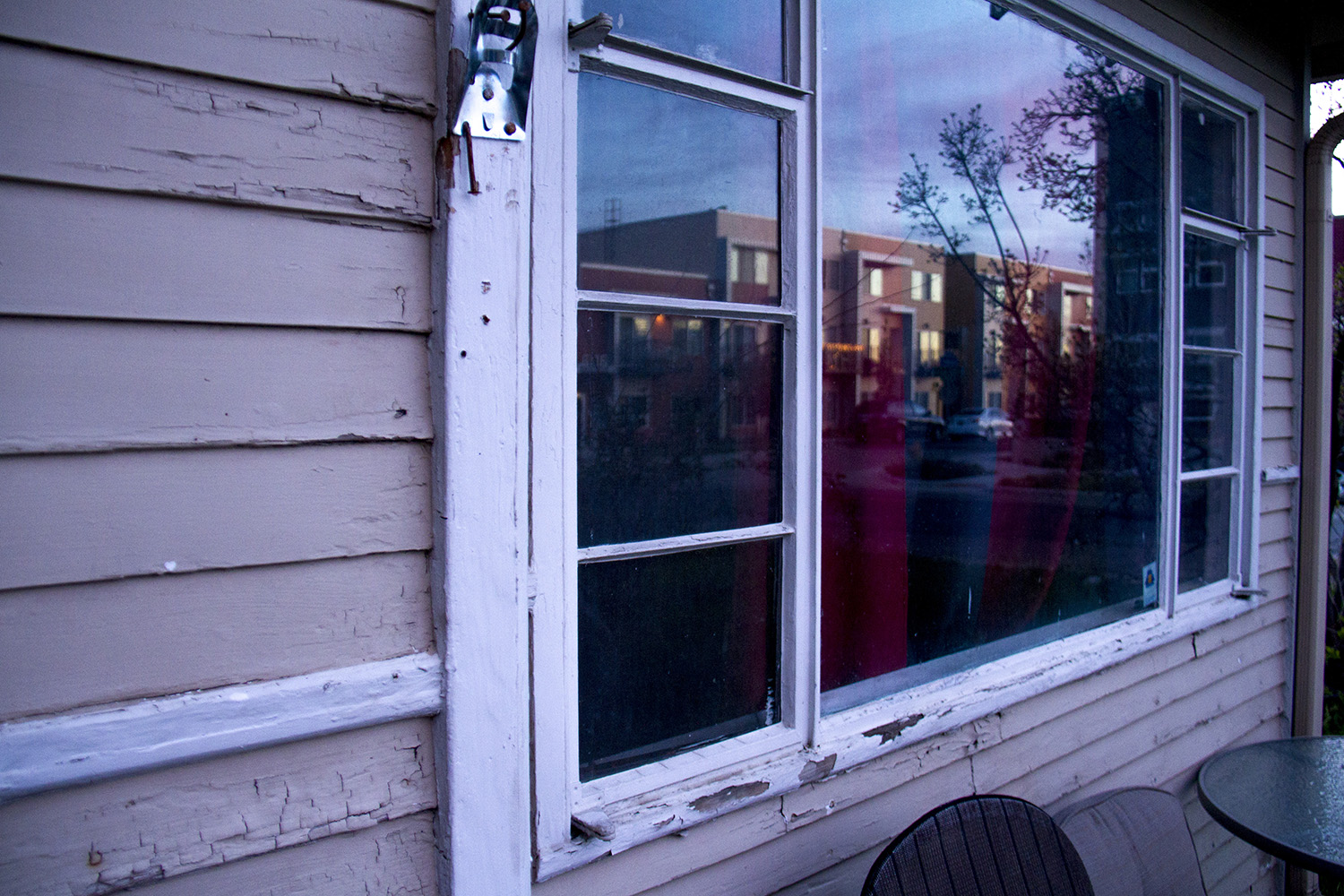 New chic condos seen in the reflection of Mark Rodriguez's older rented home.
denver; colorado; chaffee park; highlands; kevinjbeaty; megan arellano; flip; development; homes; houses; property values