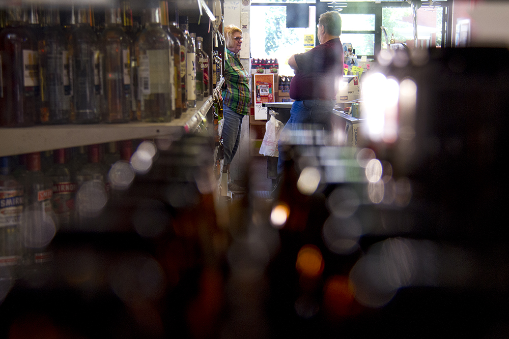 Logan Liquors owner Lore Spanbauer behind the counter of her small family-owned store in Denver's Speer neighborhood. (Kevin J. Beaty/Denverite)
logan liquors; retail; beer; kevinjbeaty; denverite; denver; colorado;