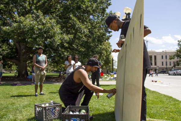Artist Chevy (right) and one who wished not to be named begin work on a "Black Lives Matter" painting at the Civic Center Park occupation on July 9, 2016. (Kevin J. Beaty/Denverite)
black lives matter; civic center park; occupy; kevinjbeaty; denver; denverite; colorado; protest;