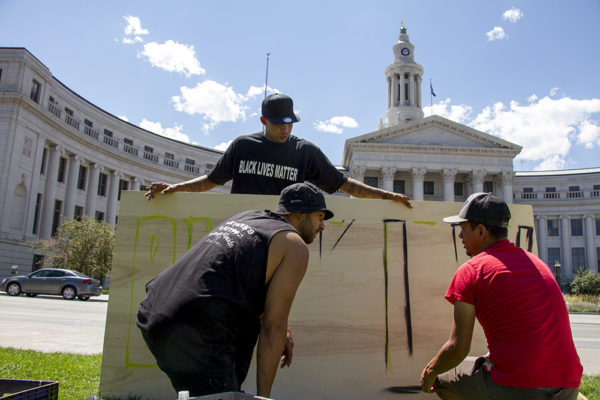 Artist Chevy (back), Gamma (right), and one who wished not to be named begin work on a "Black Lives Matter" painting at the Civic Center Park occupation on July 9, 2016. (Kevin J. Beaty/Denverite)
black lives matter; civic center park; occupy; kevinjbeaty; denver; denverite; colorado; protest;