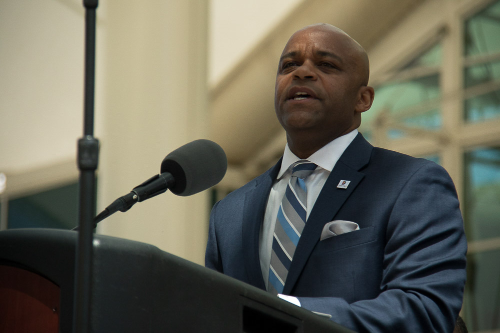 Mayor Michael Hancock addresses a crowd for State of the City at DIA. (Chloe Aiello/Denverite)