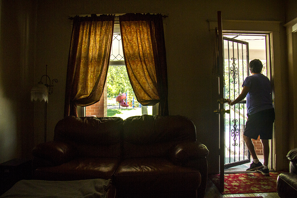Diane Medina peers through her front door into La Raza Park across the street. (Kevin J. Beaty/Denverite) la raza park; columbus park; sunnyside; chicano; denver; kevinjbeaty; denverite; colorado;