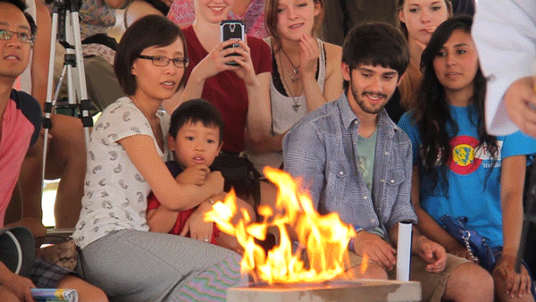 A young man is not so sure about this flaming concrete that a karate master will attempt to break with his bare hands at the Colorado Dragon Boat Festival. (Kevin J. Beaty/Denverite)