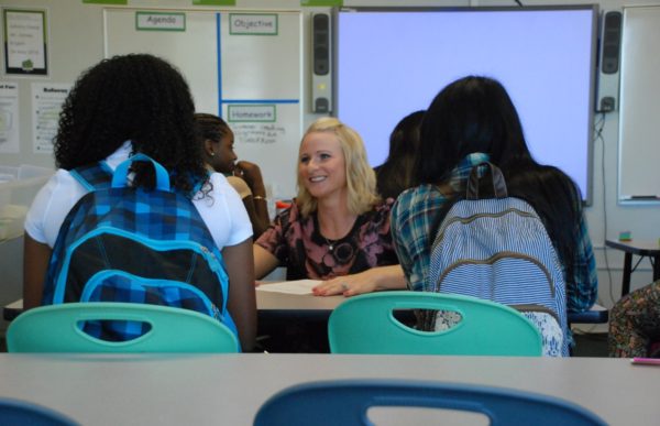 A teacher at DSST Cole High in Denver greets her students on the first day of class. ( Photo by Nicholas Garcia )