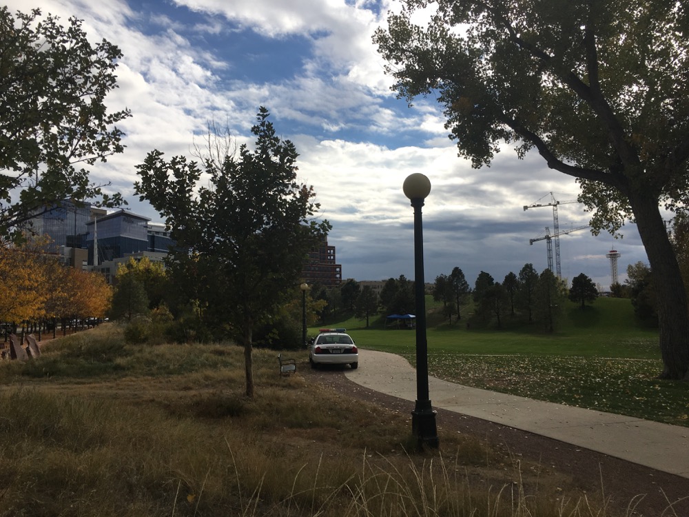 Police cars are a common sight in Commons Park. (Andrew Kenney/Denverite)