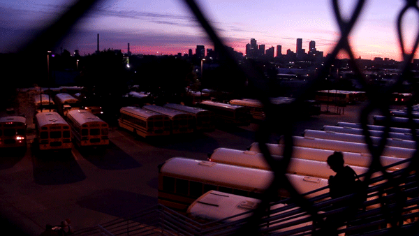 The sun rises over Denver, as seen from Denver Public Schools' Hilltop Bus Terminal, the mothership of their daily logistics operation. (Kevin J. Beaty/Denverite)