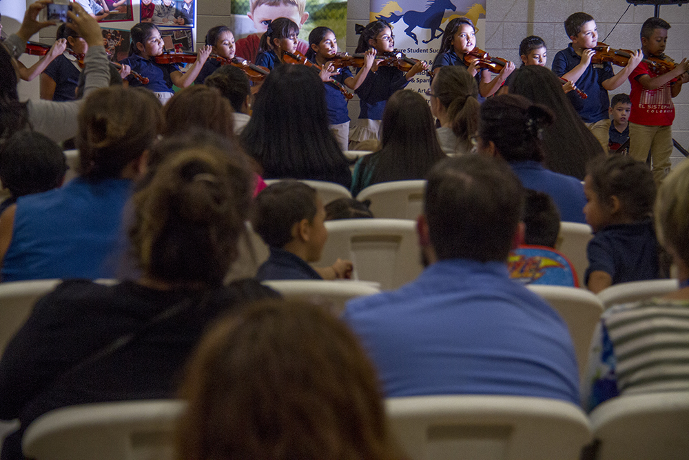 Students learning to play violin as part of the El Sistema program perform at Swansea Elementary. (Kevin J. Beaty/Denverite) elyria swansea; swansea elementary; kids; school; hancock; development; gentrification; displacement; kevinjbeaty; denverite; denver; colorado;