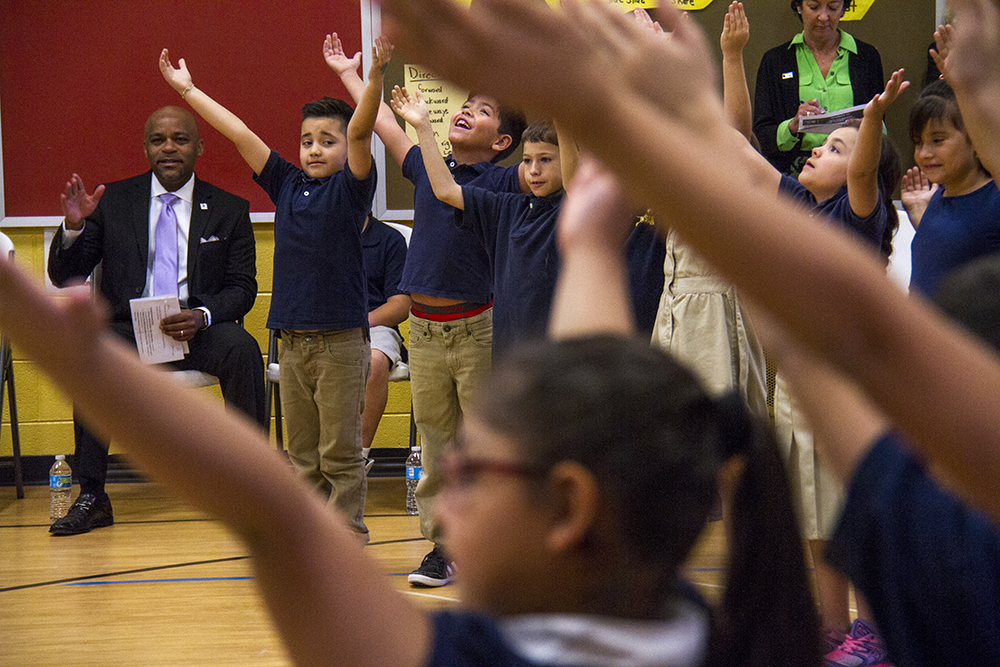 Mayor Michael Hancock watches students sing America the Beautiful. (Kevin J. Beaty/Denverite) elyria swansea; swansea elementary; kids; school; hancock; development; gentrification; displacement; kevinjbeaty; denverite; denver; colorado;
