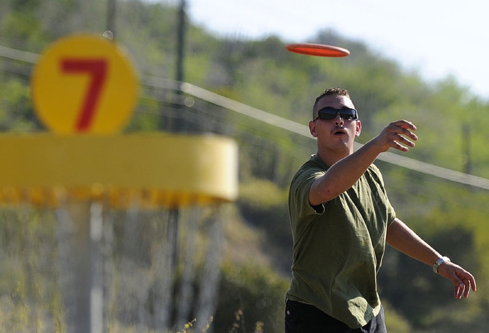 A man plays disc golf at Guantanamo Bay.