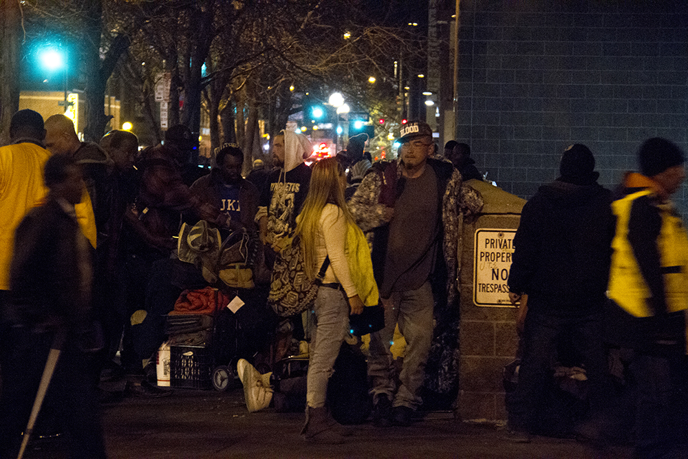 About a hundred or so people hang out on the corner of Lawrence and Broadway just one day after so-called "homeless sweeps" by the city. (Kevin J. Beaty/Denverite)
camping ban; right to rest; denver rescue mission; denver; colorado; homeless; denverite; kevinjbeaty;