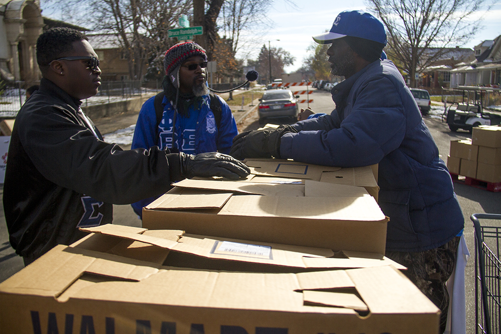 Van McGee (right to left), Mayo Thompson and Terri Nelson stand around boxes of donated food outside of the High Street United Methodist Church. Nov. 11, 2016. (Kevin J. Beaty/Denverite) High Street United Methodist Church; five points; bruce randolph; thanksgiving; volunteer; charity; community service; kevinjbeaty; denver; denverite; colorado;