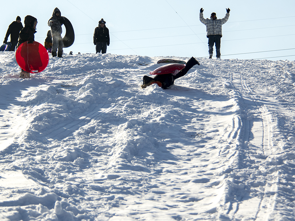 Adam Muniz cheers in the aftermath of his daughter Isis' sled run over a ramp. Dec. 17, 2016. (Kevin J. Beaty/Denverite)
snow day; winter; sledding; denver; denverite; colorado; kevinjbeaty;