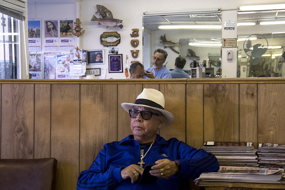 Andrés Neidig waits to get a haircut at Jigg's Barber Shop on Santa Fe Drive, which he's been patronizing since 1989. March 21, 2017. (Kevin J. Beaty/Denverite)
denver; colorado; kevinjbeaty; denverite; santa fe art district; lincoln park; haircut;