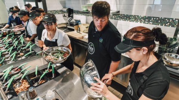 MAD Greens team members building salads. (Courtesy of MAD Greens)