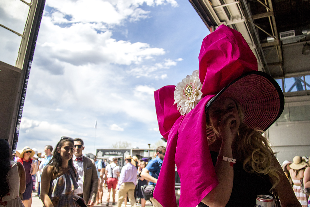Cindy Pick and her large pink-bowed hat. "It's amazing what hot glue will do." A Kentucky Derby party at Stanley Marketplace, May 6, 2017. (Kevin J. Beaty/Denverite)
stanley marketplace; kentucky derby; aurora; kevinjbeaty; denverite; colorado;