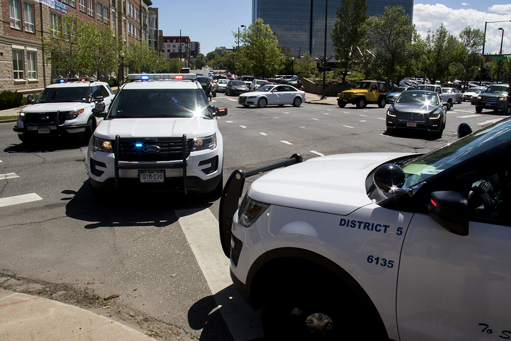DPD cruisers blocking the intersection of Speer Boulevard and 8th Avenue. (Kevin J. Beaty/Denverite)