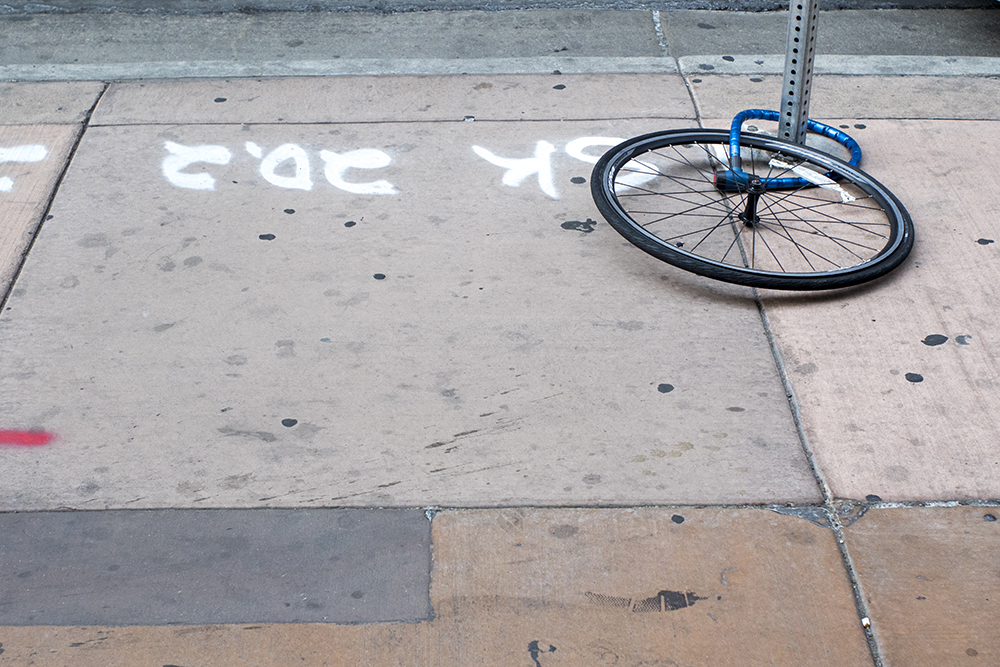 A lonely wheel without a frame downtown. (Kevin J. Beaty/Denverite)