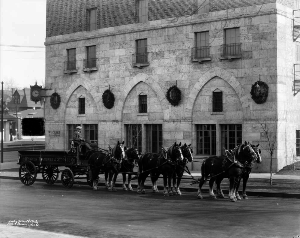 A man sits on a horse-drawn delivery wagon Jan. 23, 1928, on Colfax Avenue near Vine Street in the Cheesman Park neighborhood of Denver. (Rocky Mountain Photo Co./Denver Public Library/X-24433)