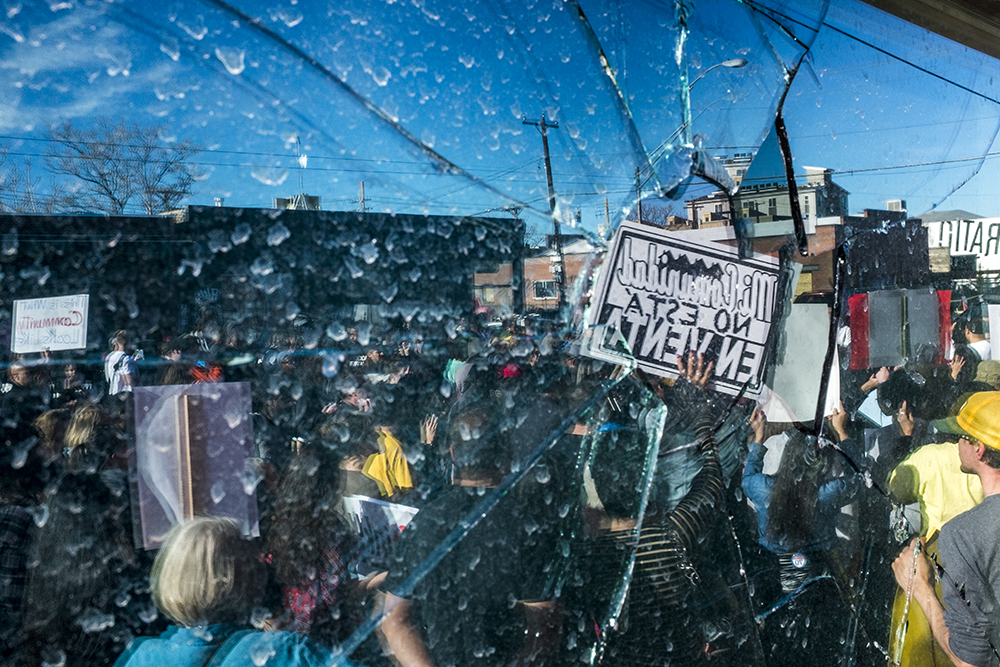A broken window at Ink! Coffee in Five Points during a protest, Nov. 25, 2017. (Kevin J. Beaty/Denverite) kevinjbeaty; denver; denverite; colorado; ink coffee; five points; rino; gentrification; protest;