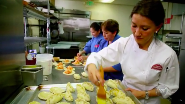 Lorena Cantarovici inside the kitchen at Maria Empanada for a Food Network segment.