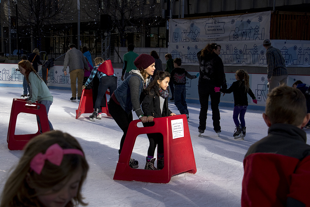 Silvia Rascon skates with her daughter, Jasaidi, on a sunny Saturday at Skyline Park, Dec. 10, 2017. (Kevin J. Beaty/Denverite)