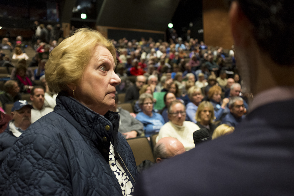 Gail Lavin, who taught here at Cherry Creek High School, grills Mike Coffman on gun violence during his town hall event, Feb. 21, 2018. (Kevin J. Beaty/Denverite) copolitics; town hall; mike coffman; greenwood village; denver; colorado; denverite; kevinjbeaty;