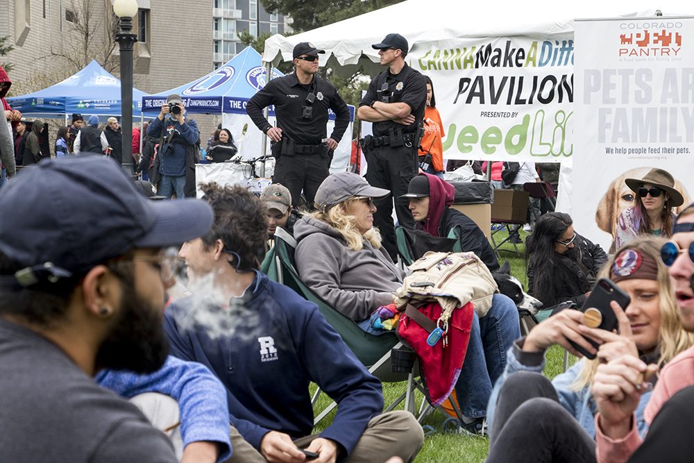 Denver Police officers stand on patrol as people smoke marijuana during Denver's 2018 Mile High 420 Festival, April 20, 2018. (Kevin J. Beaty/Denverite)
420; stoner; denver; denverite; colorado; kevinjbeaty;