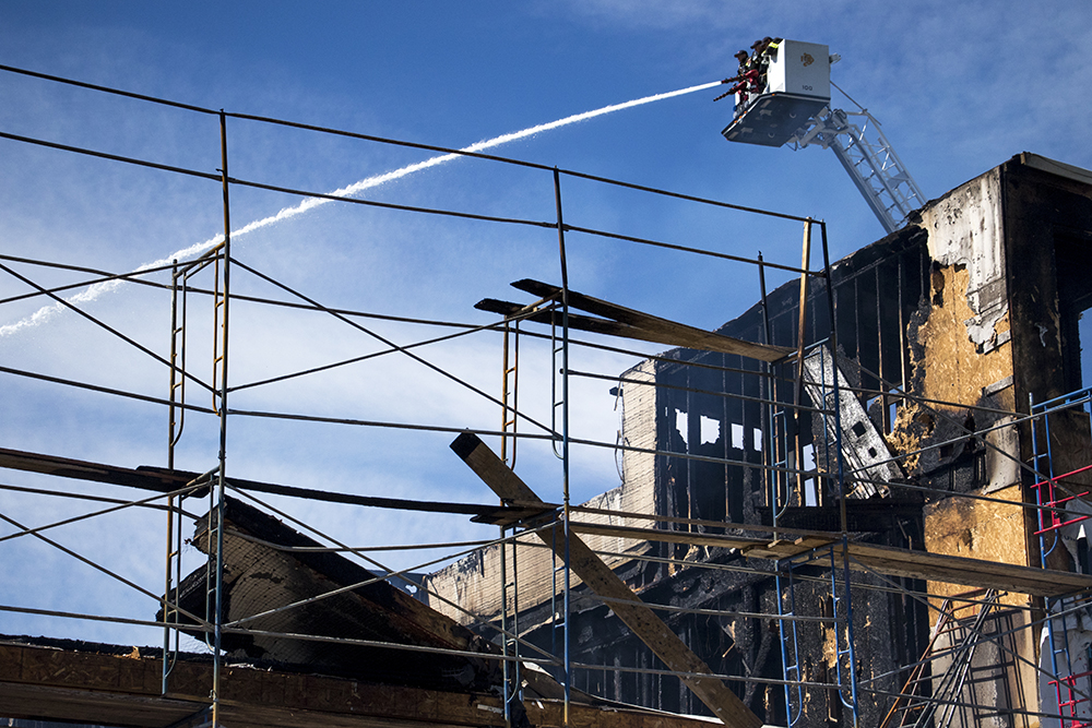 The Denver Fire department sprays water on a construction site that burned down at 1930 Grove Street, May 10, 2018. (Kevin J. Beaty/Denverite)
denver; colorado; denverite; kevinjbeaty; firefighting; fire; construction;