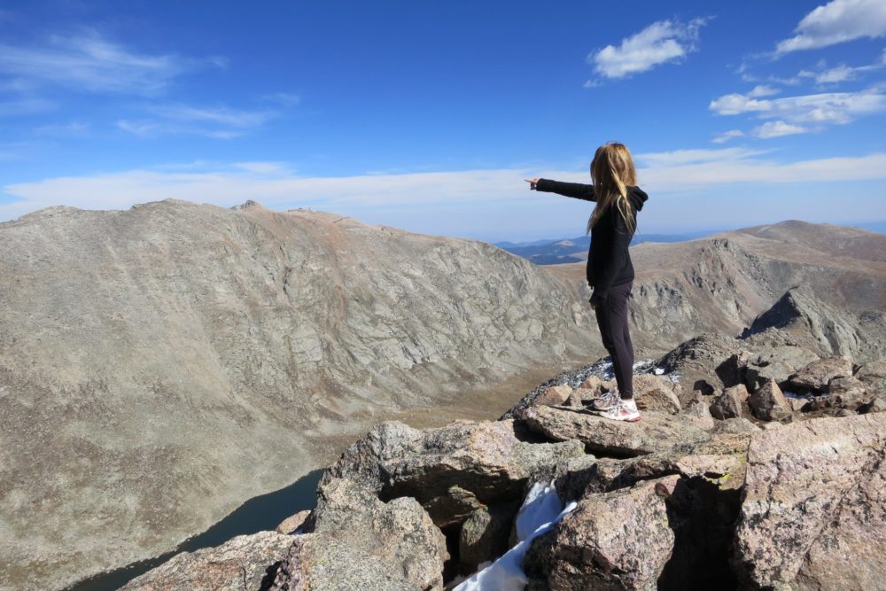 Your author pointing at Mt Evans from atop Mt. Bierstadt. (Courtesy of Gordon Dean)