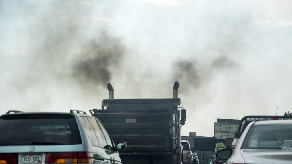 A truck belches exhaust on I-25, June 15, 2018. (Kevin J. Beaty/Denverite)