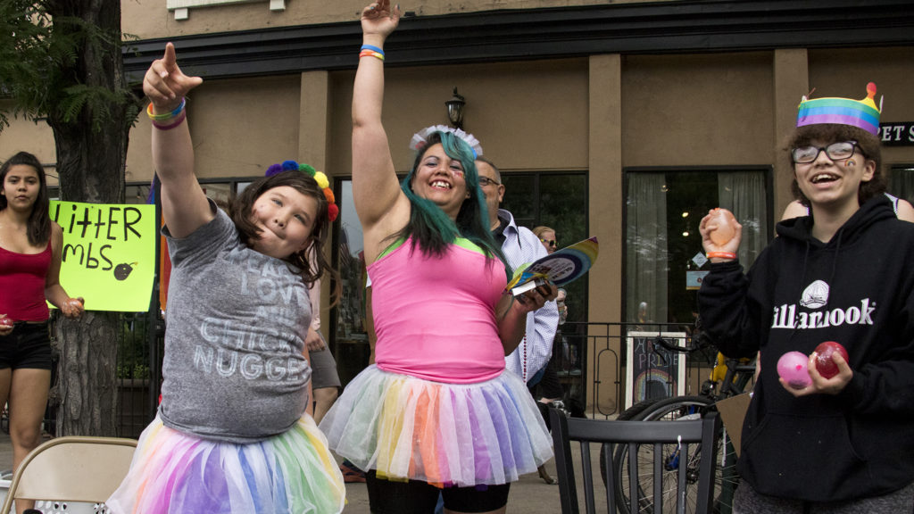 Jaelyn, 10, (left to right) and Bree King hurl glitter bombs onto the Denver PrideFest parade, June 17, 2018. (Kevin J. Beaty/Denverite)