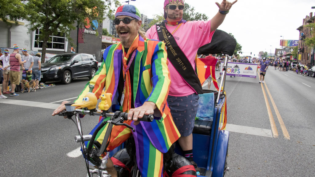 Ron Rickshaw and Gay Onyx Steele ride a pedicab down Colfax during the Denver PrideFest parade, June 17, 2018.