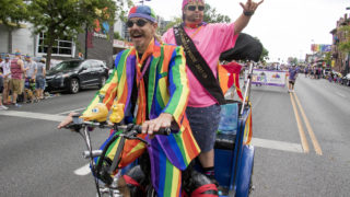 Ron Rickshaw and Gay Onyx Steele ride a pedicab down Colfax during the Denver PrideFest parade, June 17, 2018.