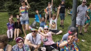 Spectators watch as the Denver PrideFest parade processes out of Cheesman Park, June 17, 2018. (Kevin J. Beaty/Denverite)