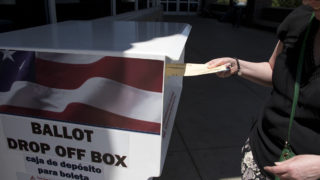 Lisa Lockman casts a ballot at the Denver Human Services building in Sun Valley on primary election day, June 26, 2018. (Kevin J. Beaty/Denverite)