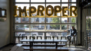 Kevin Patrick, who says he's "probably" improper, hangs out during Improper City's soft opening in RiNo. Five Points, July 9, 2018. (Kevin J. Beaty/Denverite)