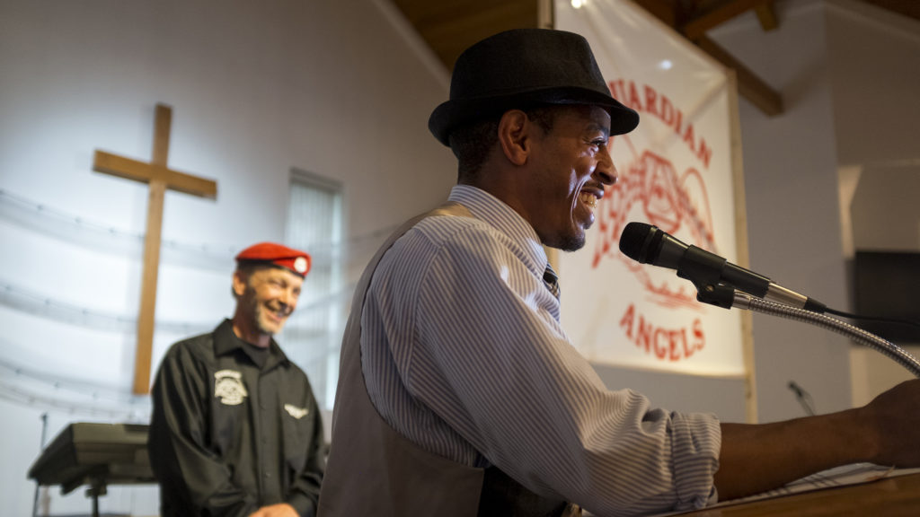 Martin Luther King Jr. Day Marade vice chair Christian Steward reads a proclamation by Mayor Hancock to the Colorado Guardian Angels, July 15, 2018. (Kevin J. Beaty)