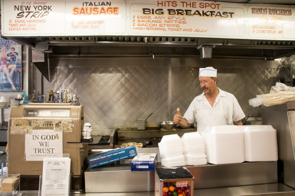 Martin Miramontes behind the grill at Swift's Breakfast House on Santa Fe Drive, Aug. 1, 2018. (Kevin J. Beaty/Denverite)