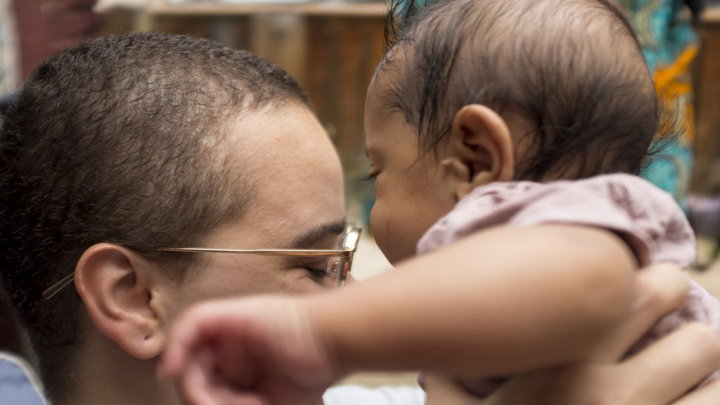 Avery Rao holds her son Thao Vishnu at the Whittier Cafe as she discusses Denver Black and Latina Breastfeeding Week, Aug. 22, 2018. (Kevin J. Beaty/Denverite)