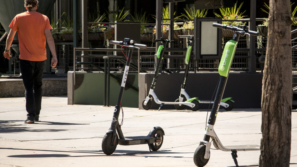 Bird and Lime scooters parked near Coors Field, Aug. 27, 2018. (Kevin J. Beaty/Denverite)