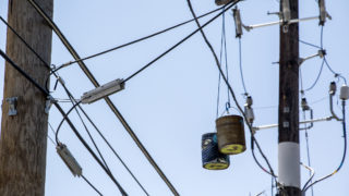 Paint cans hang over a RiNo alleyway. Five Points, Aug. 29, 2018. (Kevin J. Beaty/Denverite)