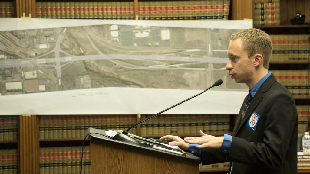 Joel Minor, an attorney with Earthjustice, is the first to provide public comment as the Denver Board of Public Health and Environment holds a special hearing on a request for the I-70 expansion project to breach normal legal limits on noise pollution, Sept. 6, 2018. (Kevin J. Beaty/Denverite)