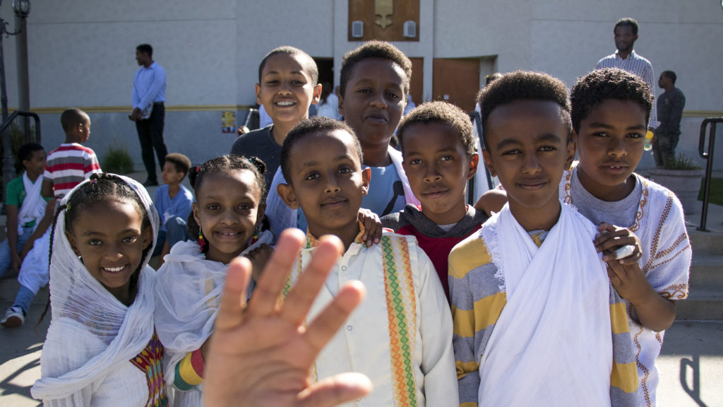 Kids clamor for a portrait during Ethiopian New Year at St. Mary Ethiopan Orthodox Church in Aurora, Sept. 9, 2018. (Kevin J. Beaty/Denverite)