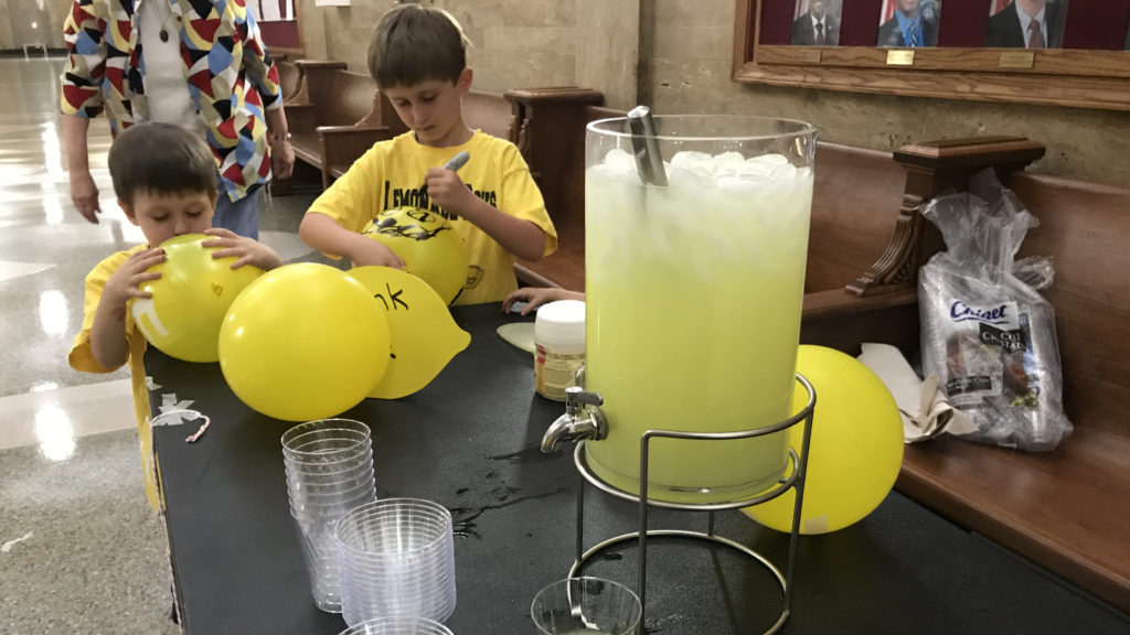 Brothers William Guffey, 4, (left) and Ben Guffey, 7, decorate balloons outside the City Council Chambers on Monday, Sept. 17, 2018, in Denver.