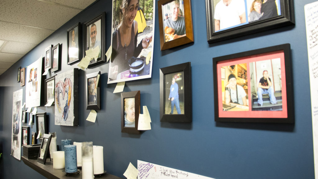 A wall of portraits of Dry Bones Denver members who have passed away inside their City Park West headquarters, Oct. 18, 2018. (Kevin J. Beaty/Denverite)