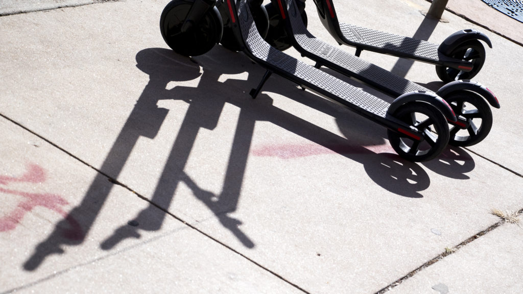 Spin scooters on the street downtown, Oct. 23, 2018. (Kevin J. Beaty/Denverite)