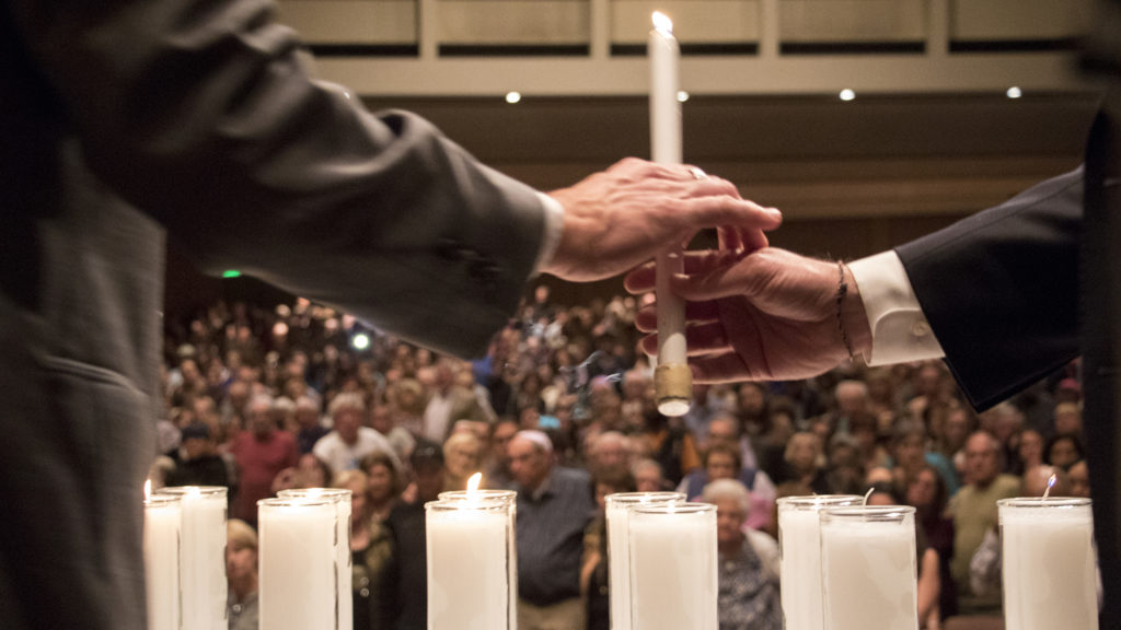 Dignitaries light candles for a victims of a mass shooting at a Pittsburgh synagogue during a vigil at Temple Emanuel, Oct. 28, 2018. (Kevin J. Beaty/Denverite)