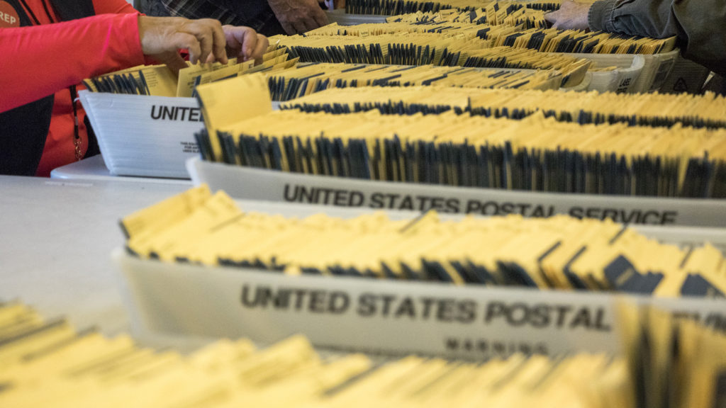 Election judges organize ballots at Denver Elections Division's downtown headquarters, Oct. 31, 2018. (Kevin J. Beaty/Denverite)