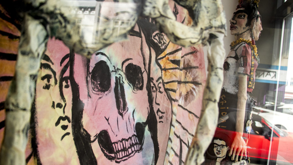 Dia de los Muertos decorations up in ReCreative's window on Santa Fe Drive, Nov. 1, 2018. (Kevin J. Beaty/Denverite)