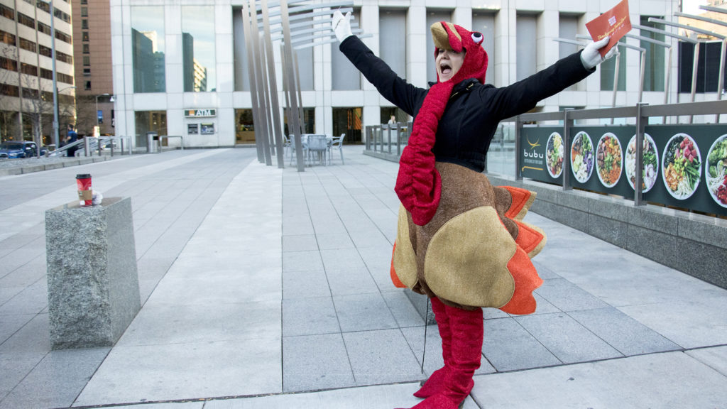 Alexxa Gagner, director of public relations for Denver Rescue Mission, celebrates the first donation of their holiday turkey drive outside of Republic Plaza, Nov. 2, 2018. (Kevin J. Beaty/Denverite)